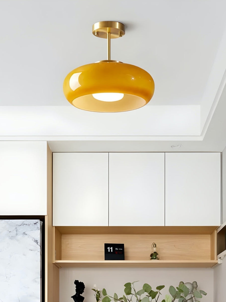 Amber glass ceiling light fitted close to the ceiling above a pale kitchen unit