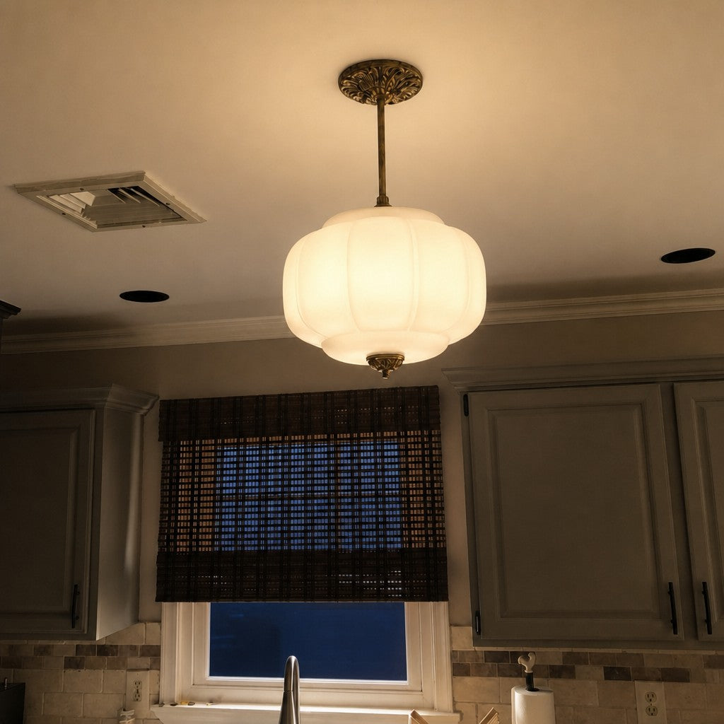 Elva milk glass ceiling light lit in the evening above a kitchen sink