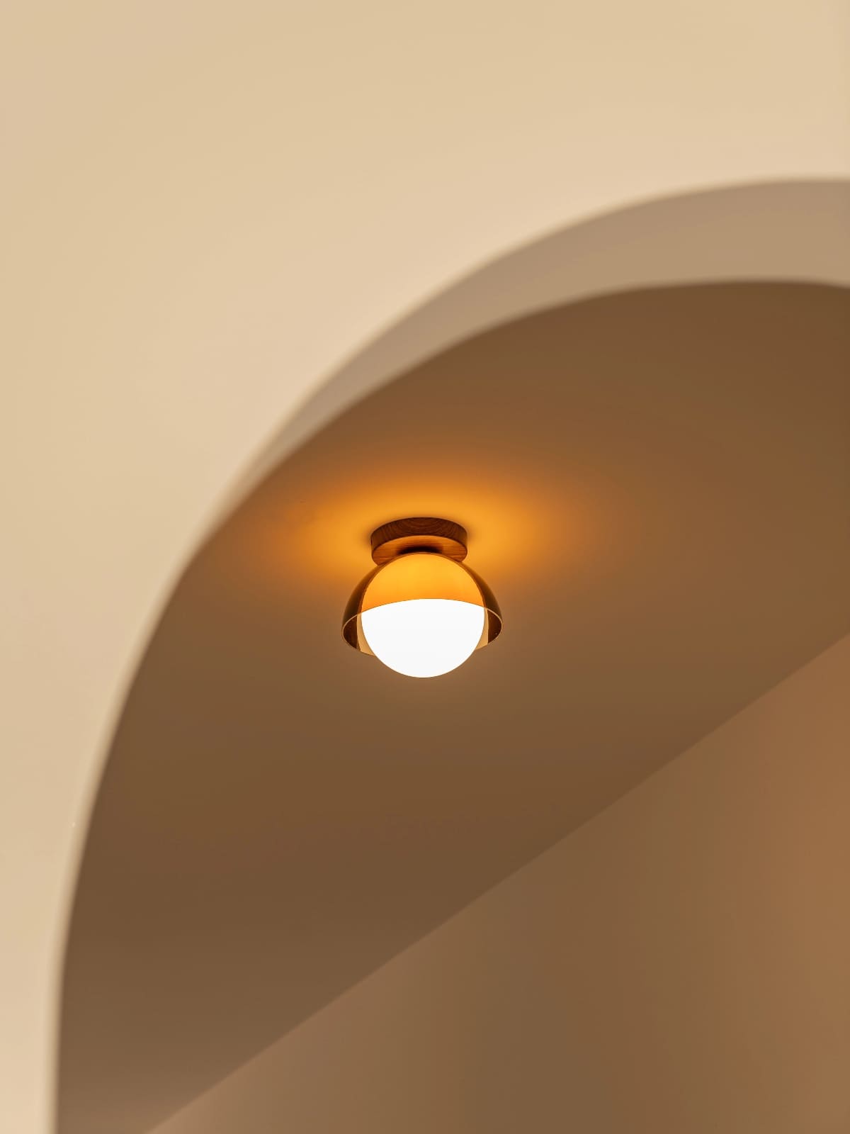 Suno sunset ceiling light glowing in a curved neutral hallway alcove