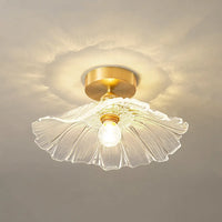 Close view of the Calo clear ribbed glass shade and brass canopy in use
