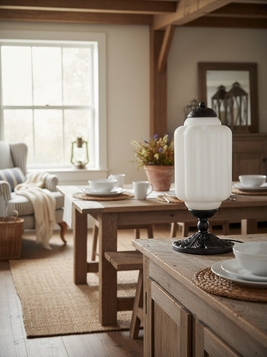 Elva glass table lamp on a dining room sideboard beside laid place settings