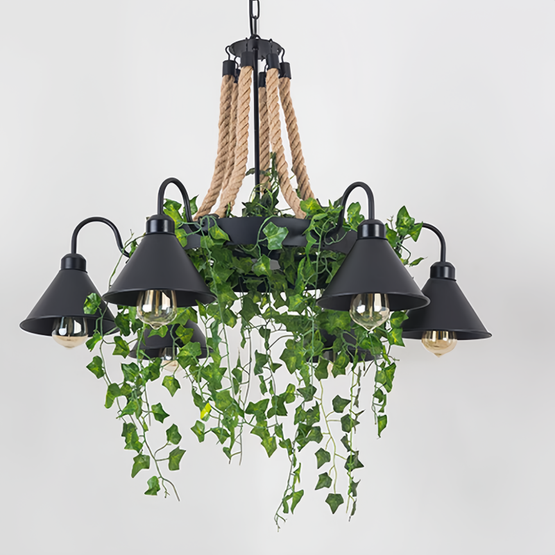 Corven six-arm ceiling light on a plain background, black metal ring on rope cords with six cone shades and trailing artificial ivy