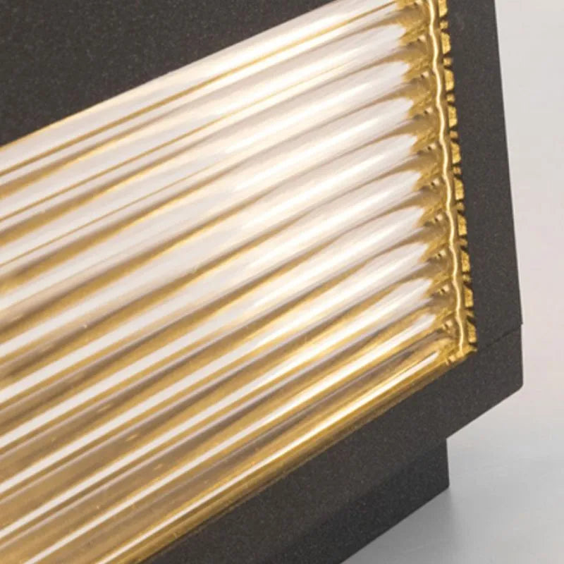 Sentry pillar cap light ribbed glass panel close-up warm golden illumination
