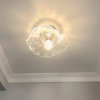 Calo petal glass ceiling light lit against a ceiling with plaster cornice