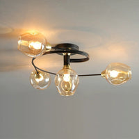 Close view of the Orvello amber glass shades and brass collars on the black arm