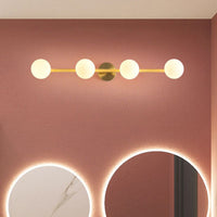 Sevra four globe wall light lit on a terracotta bathroom wall