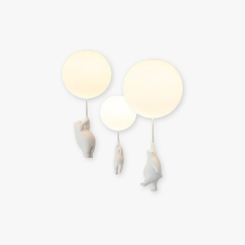 Wisto ceiling light with three white balloon shades and three hanging resin bears on a plain white background