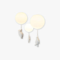 Wisto ceiling light with three white balloon shades and three hanging resin bears on a plain white background
