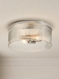 Riva ribbed glass flush mount ceiling light with a polished nickel frame against a plain wall