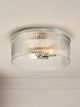 Riva ribbed glass flush mount ceiling light with a polished nickel frame against a plain wall
