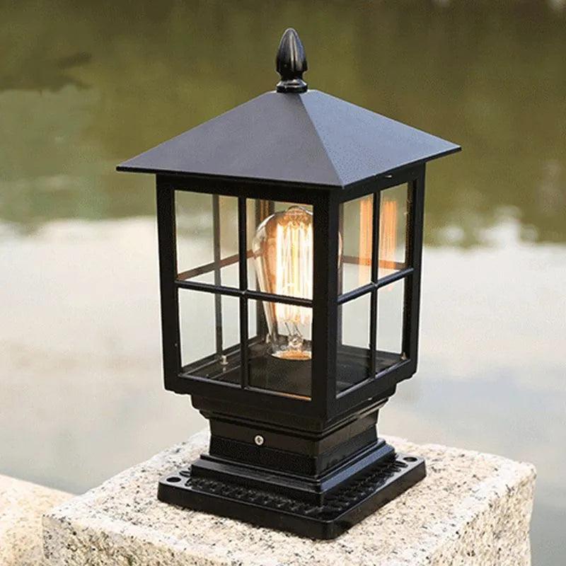 Close view of the Ashlow post lantern showing the grid glazing bars, acorn finial and stepped cast base