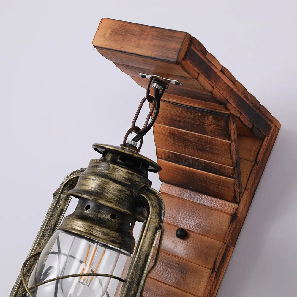 Angled view of the Kenva pine bracket and chain suspension above the bronze lantern