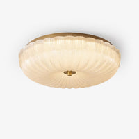 Hala ripple glass ceiling light with brass tone rim on a white background