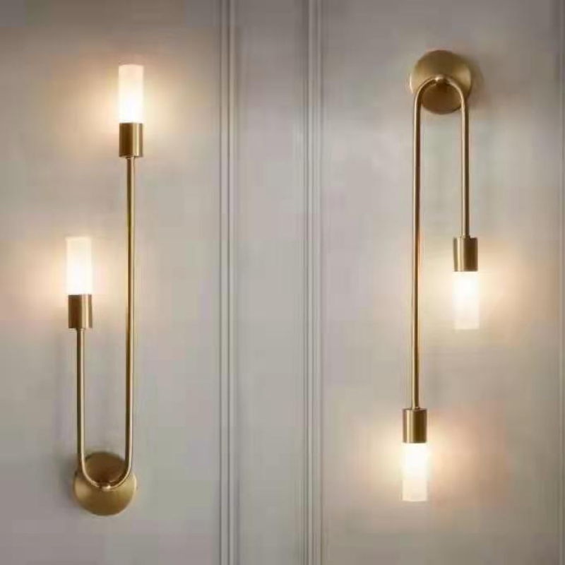 Vano dual-light gold sconces on white panelled wall