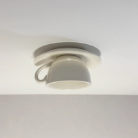 Kupa white ceramic teacup ceiling light mounted flush to a plain white ceiling