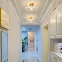 Two Calo petal glass ceiling lights fitted along a bright hallway ceiling