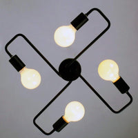 Indro ceiling light viewed from below showing four looped black arms and globe bulbs