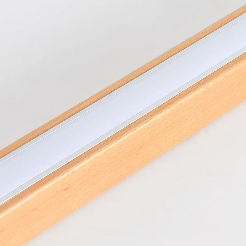 Detail of the Woda ceiling bar showing the wood grain alongside the lit diffuser strip