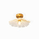 Calo petal glass ceiling light with clear ribbed shade and brass canopy on a plain white background