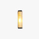 Lockhone Yoro cylinder outdoor wall light in black metal with fluted glass diffuser, lit, on a plain white background