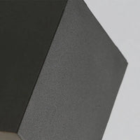 Close-up of the matt black textured metal edge and square corner of the Dovra wall light