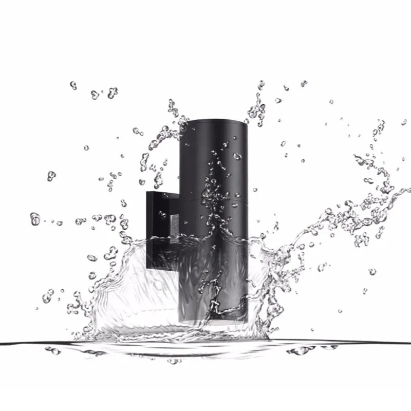Black Belvo twin-head wall light in a splash of water showing its weather resistance