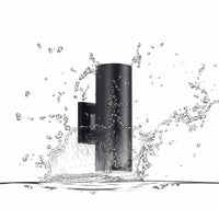 Black Belvo twin-head wall light in a splash of water showing its weather resistance