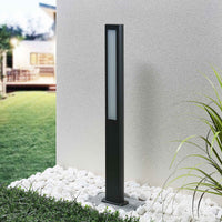 Mairo path light unlit in daylight showing the slim anthracite column and grass border