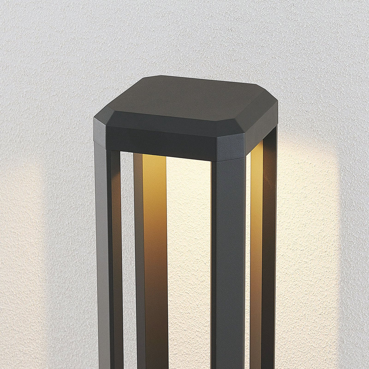 Close view of the Feryn head casting warm light down through the open aluminium frame