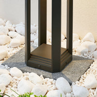 Close view of the Ryda stepped base plinth set on a paving slab among white pebbles