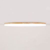 Side profile of the Nolla ceiling light showing how shallow the wood rimmed disc sits against the ceiling