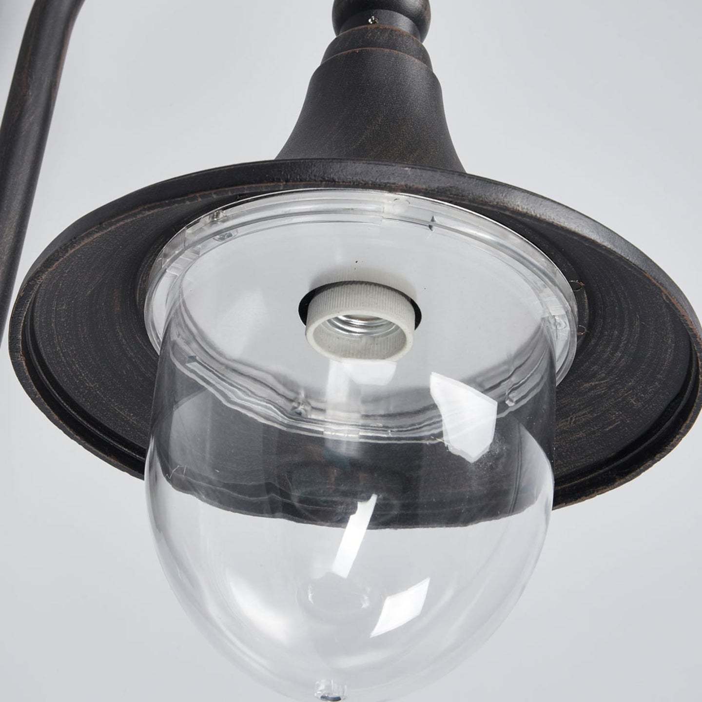 Close up under the Dafo outdoor wall light shade showing the clear domed diffuser and screw bulb holder
