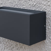 Close-up of the top of the Bexa outdoor wall light showing the upper diffuser strip that throws light up the wall