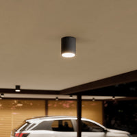 Mero Round Outdoor Ceiling Light lighting a carport at night