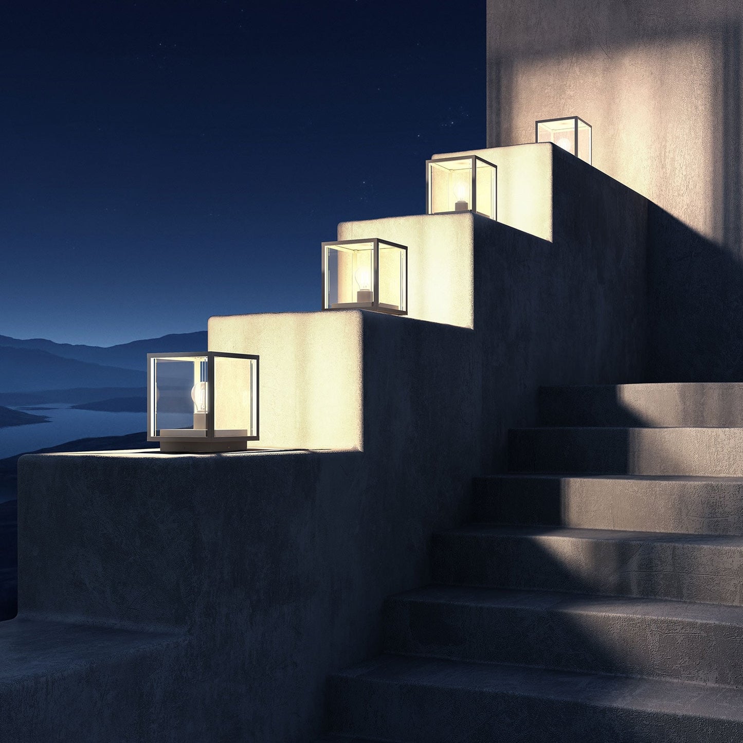 Four Anle Glass Pillar Lights lit at night along a stepped terrace wall overlooking a bay
