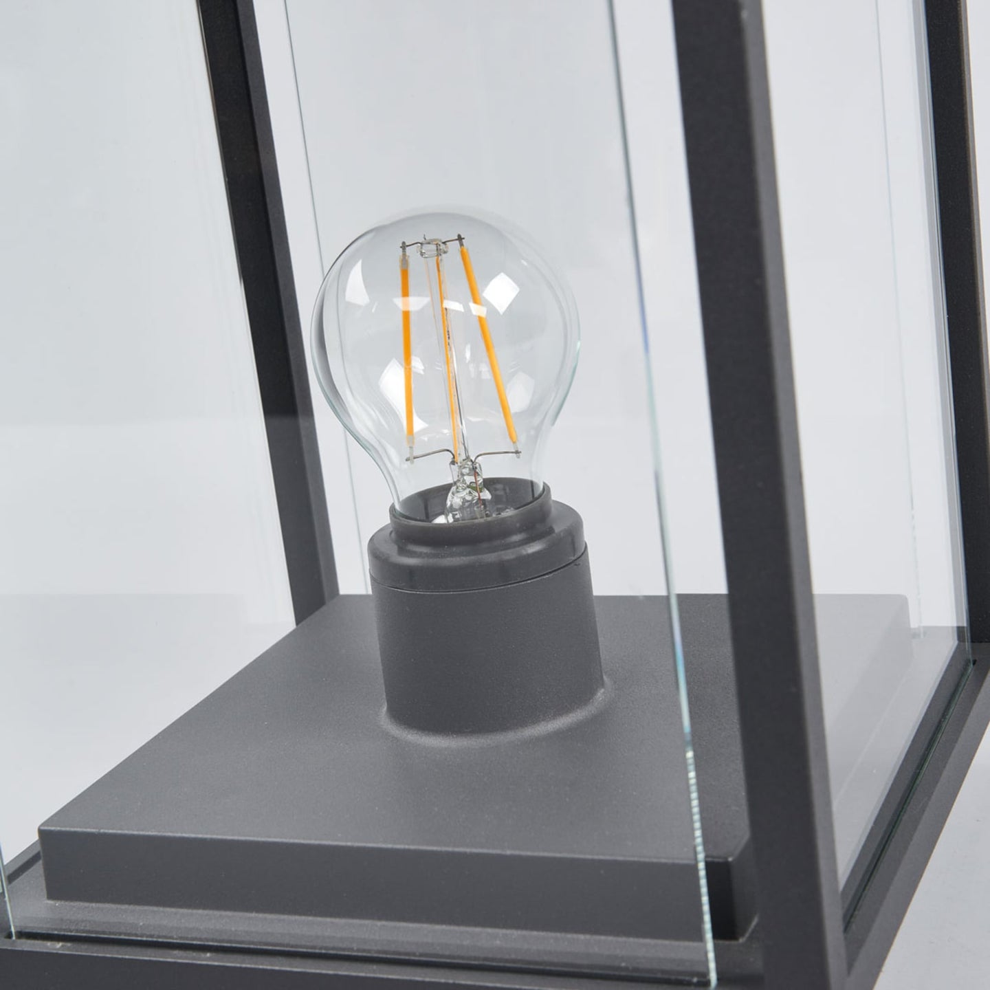 Close view of the screw fit lampholder and filament bulb inside the Anle Glass Pillar Light
