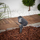 Batra Garden Spike Light in dark grey staked in a mulched border in daylight