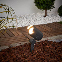 Batra Garden Spike Light angled over decking with its beam lit at dusk