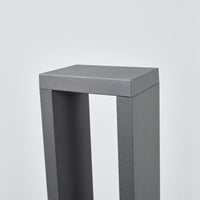 Detail of the anthracite powder-coated top corner of the Jupo path post light showing the textured metal finish