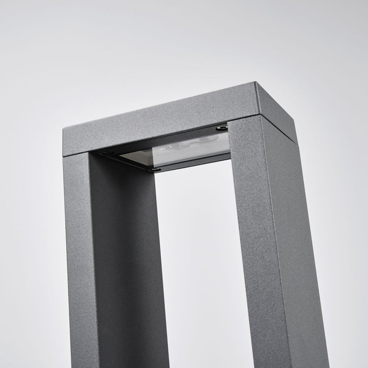 Close-up of the Jupo path post light head showing the recessed LED panel and glass cover set under the top bar