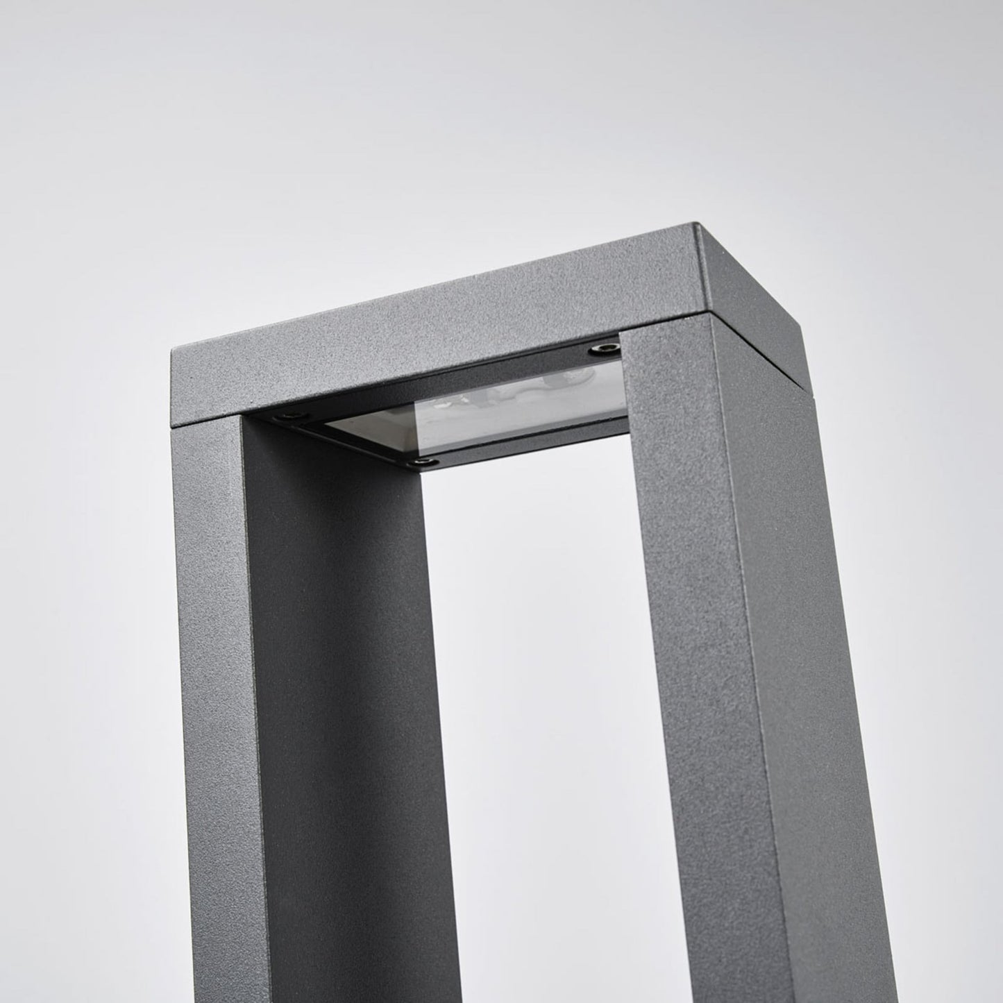 Close-up of the Jupo path post light head showing the recessed LED panel and glass cover set under the top bar