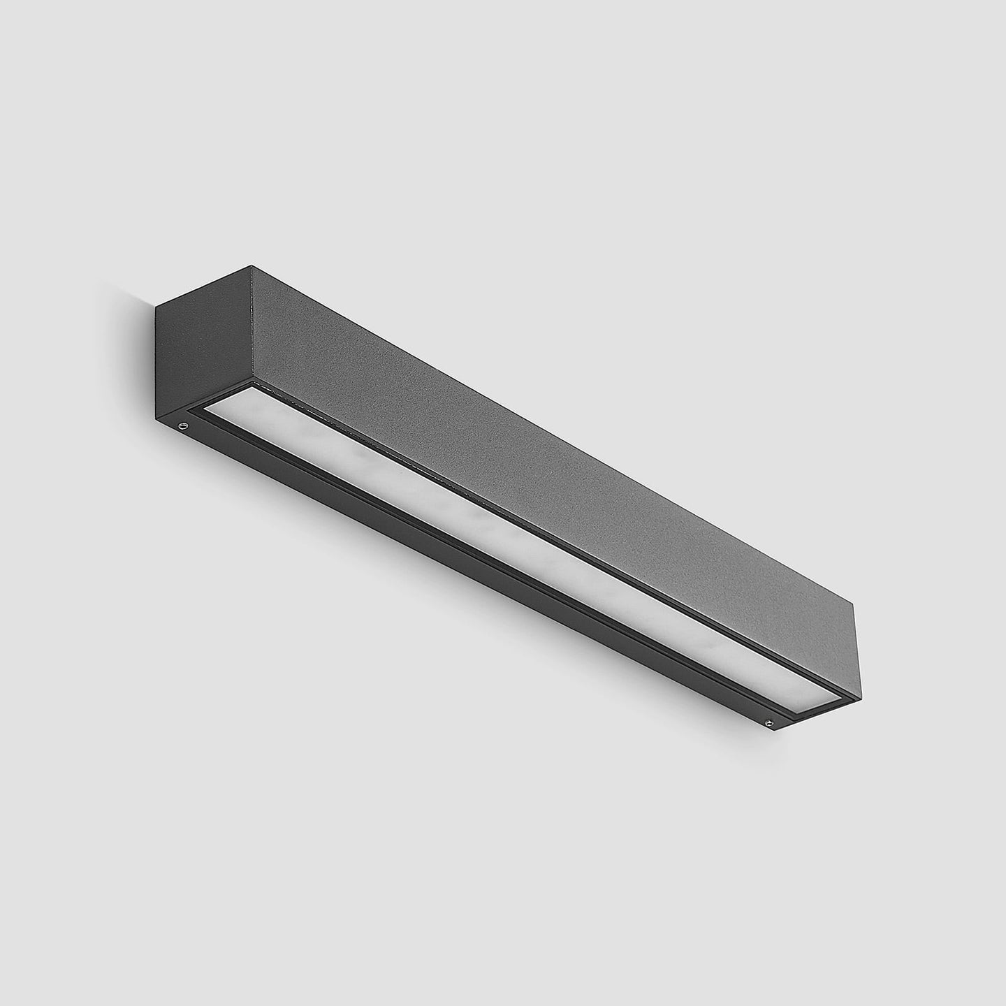 Lino Column outdoor wall light angled on a plain light grey background, showing the shallow anthracite body and the glass diffuser