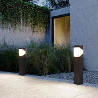 Two Kiro Pillar Post Lights lighting a terrace by a front door in the evening