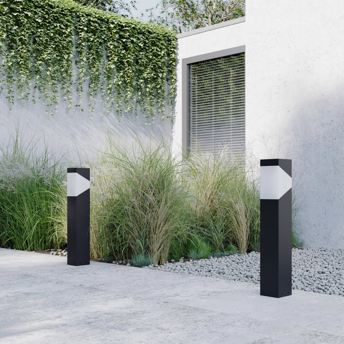 Two Kiro Pillar Post Lights along a paved garden path in daylight