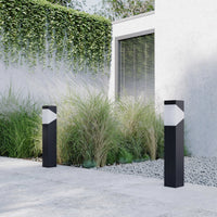 Two Kiro Pillar Post Lights along a paved garden path in daylight