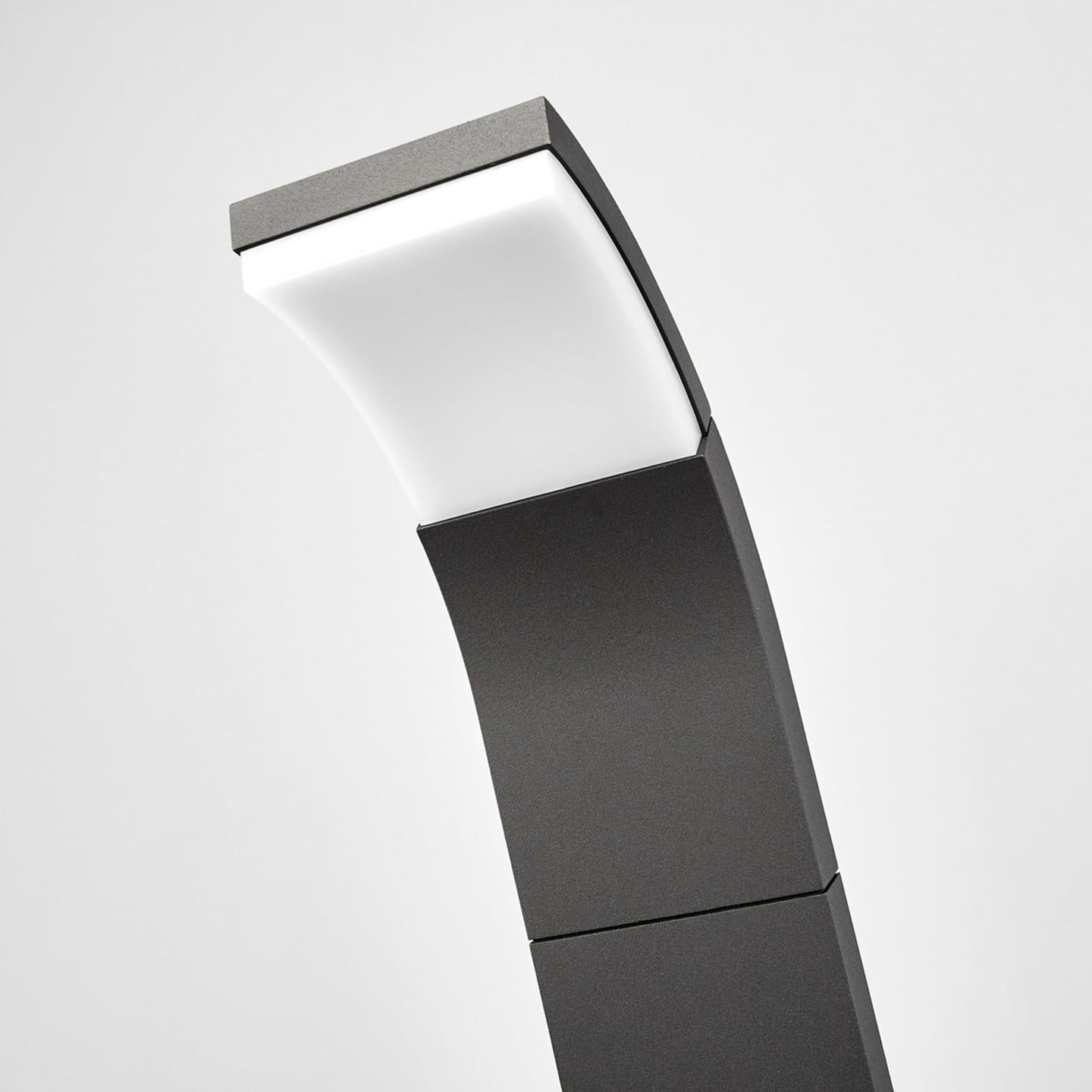Close-up of the Timo path light tilted head with the white diffuser lit in warm white