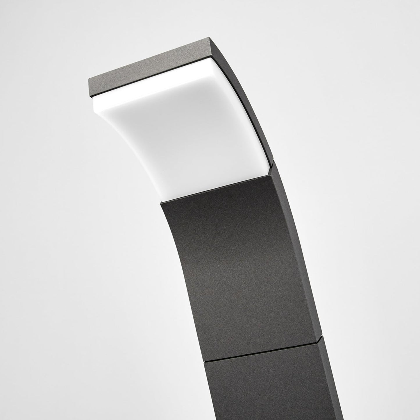 Close-up of the Timo path light tilted head with the white diffuser lit in warm white
