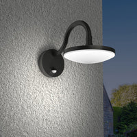 Angled view of the Finno wall light mounted on a rendered wall at dusk