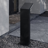 Yola Path Post Light set in grey gravel beside a paved doorway approach