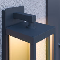Close view of the Denro squared wall bracket and the top of the lit glass frame